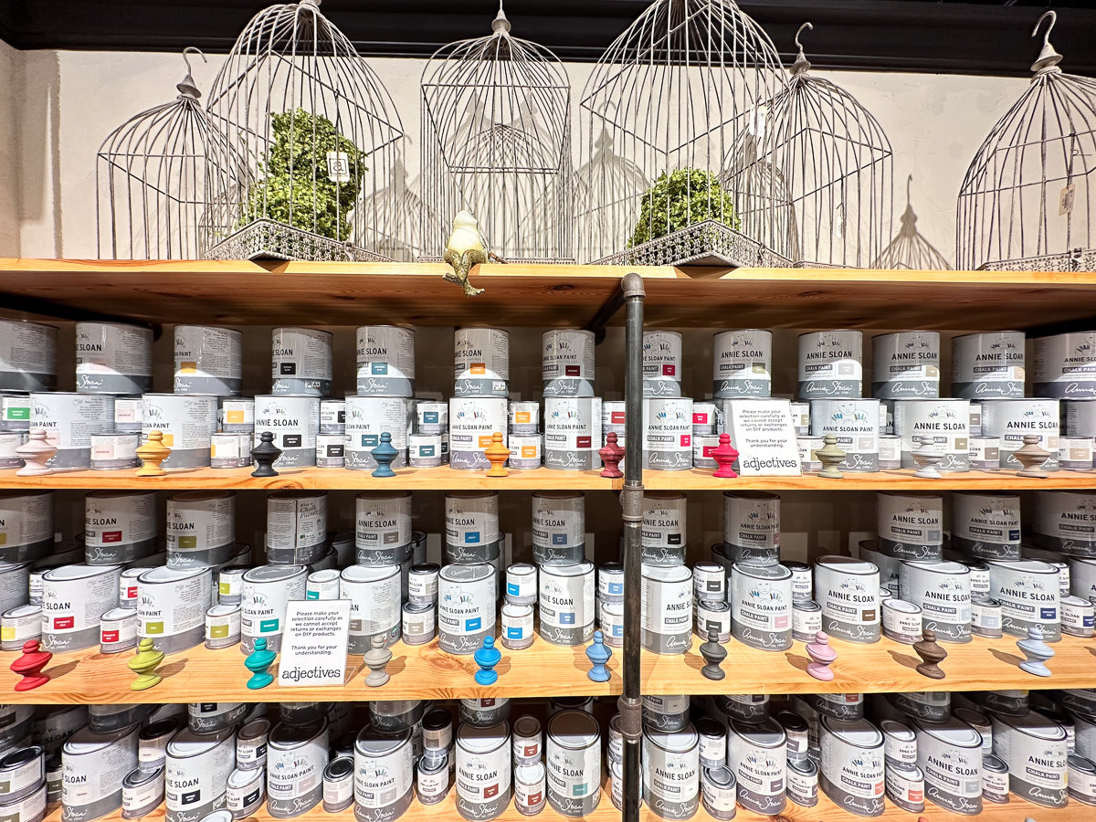 wall of shelves with paint cans